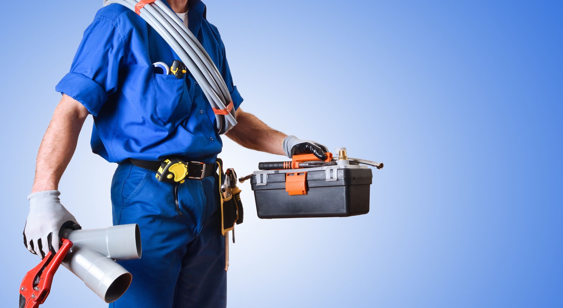 Uniformed plumber holding tools against a blue gradient background, close-up view.