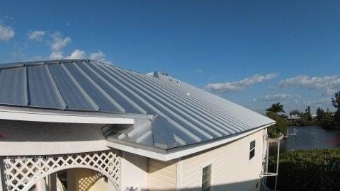 A white house with a metal roof and a gazebo in front of it — Tampa, FL — Bill Shields Roofing