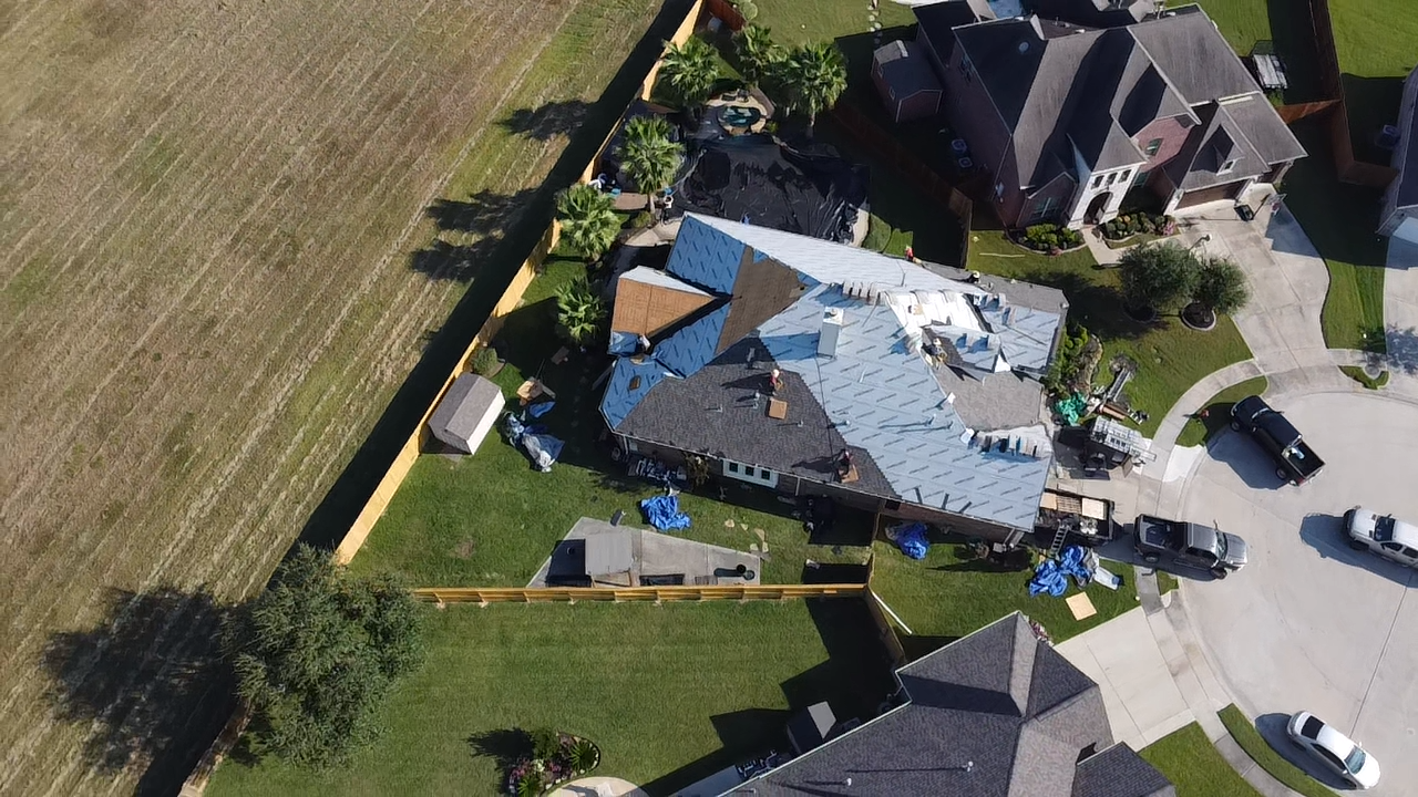 An aerial view of a house with a roof being installed.