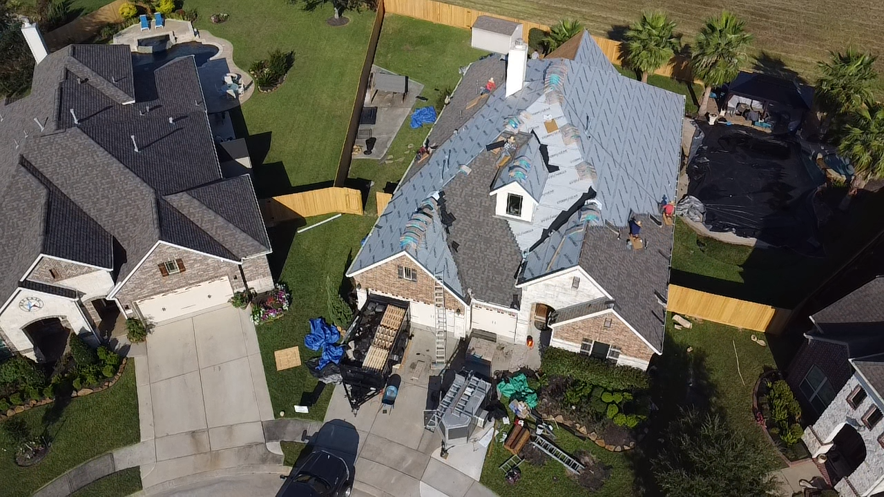 An aerial view of a house being remodeled in a residential area.