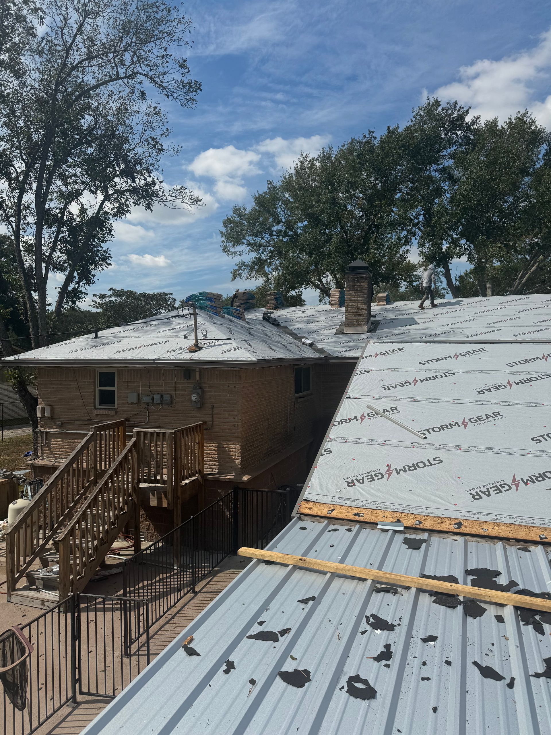 A metal roof is being installed on a house.
