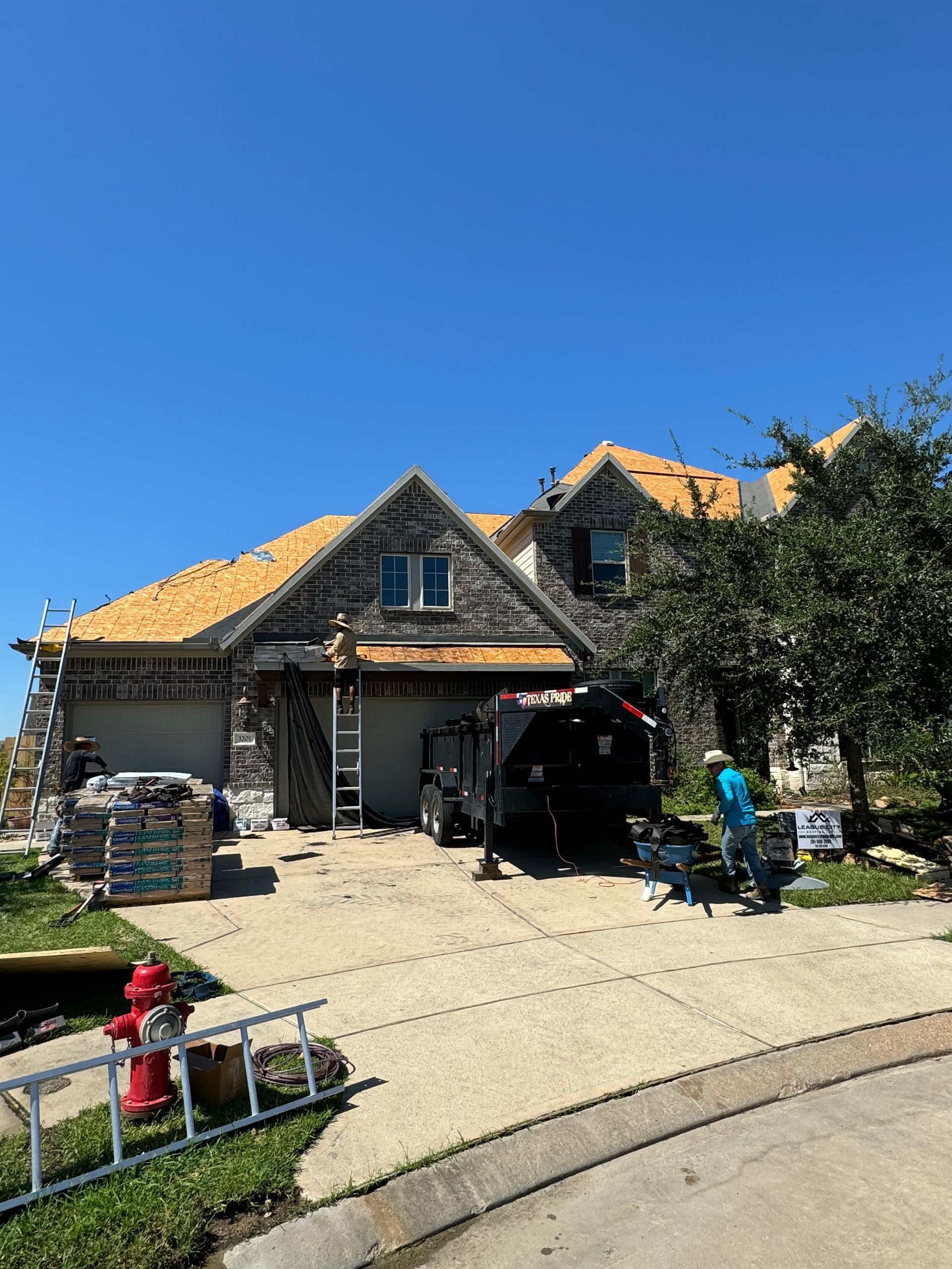 A large house with a fire hydrant in front of it is being remodeled.