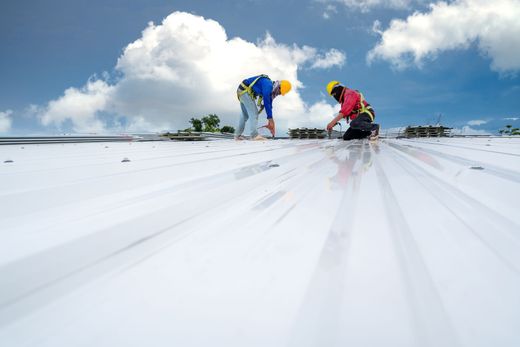 Roofers on white roof