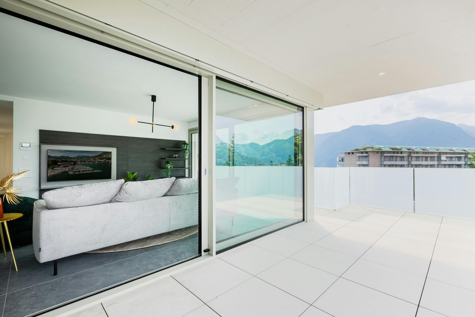 A living room with a couch and a large window