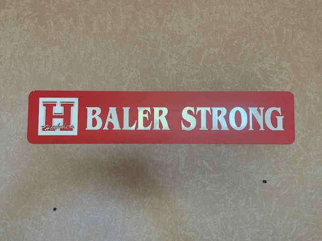 A red sign that says baler strong on it