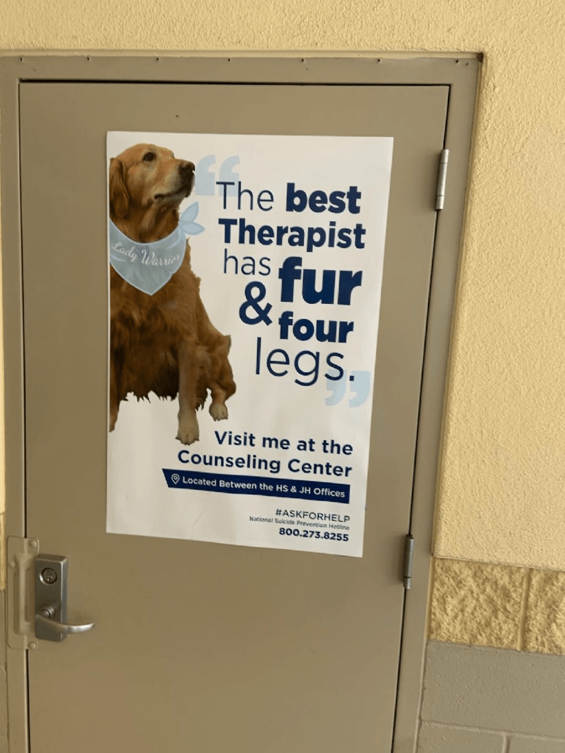A poster on a door that says the best therapist has fur and four legs
