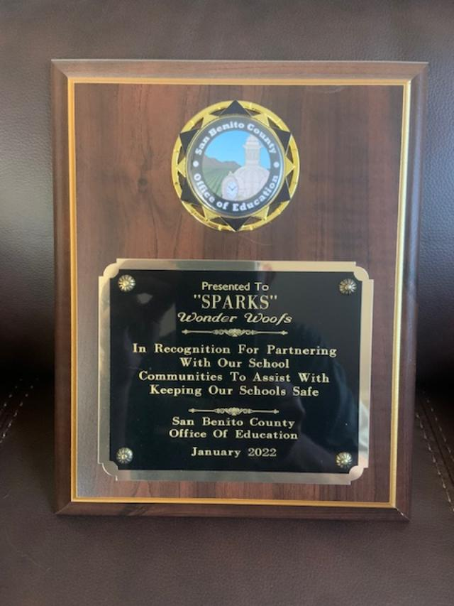 A wooden plaque that says