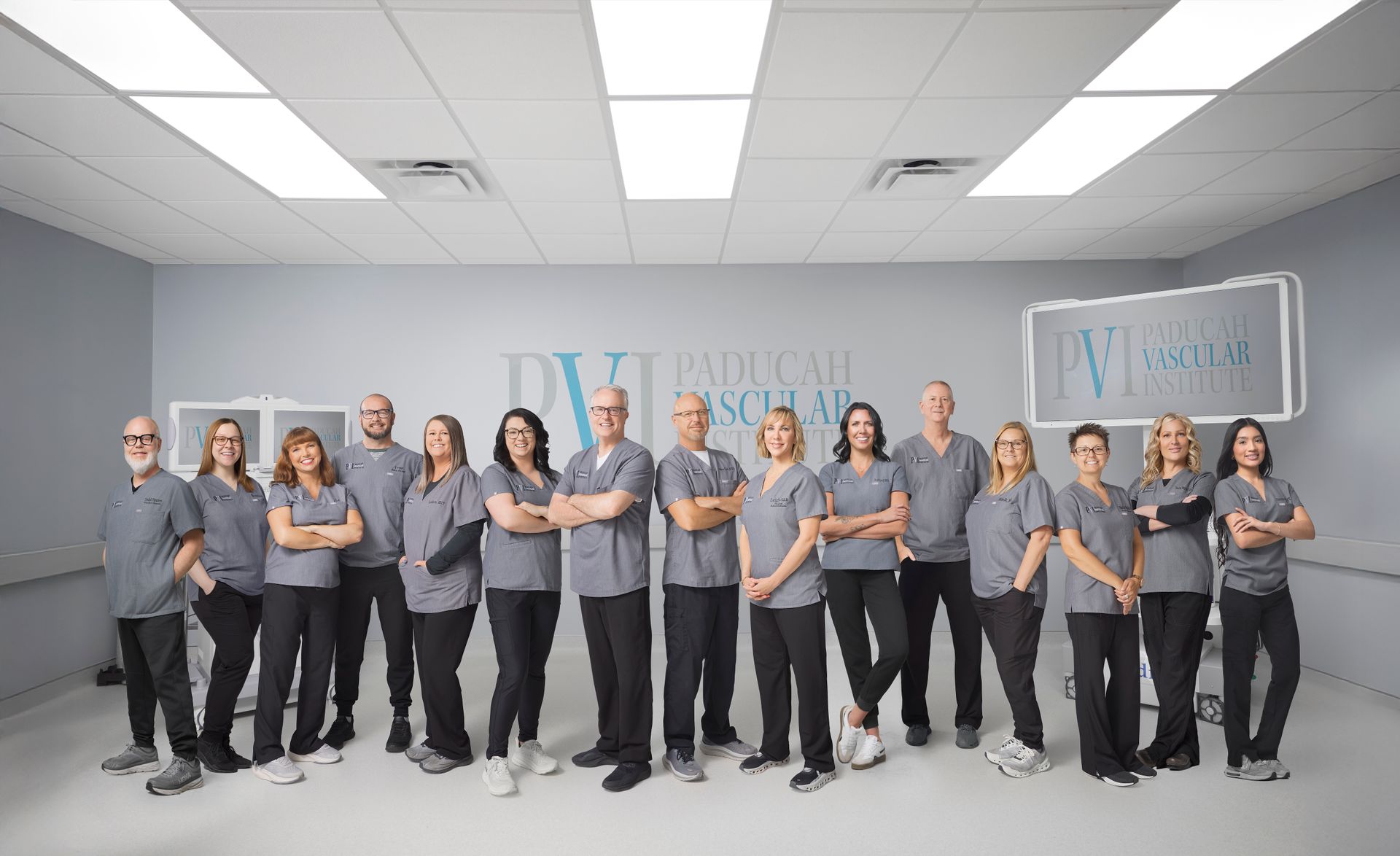 paducah vascular institute staff photo, a group of people standing in the operating room together