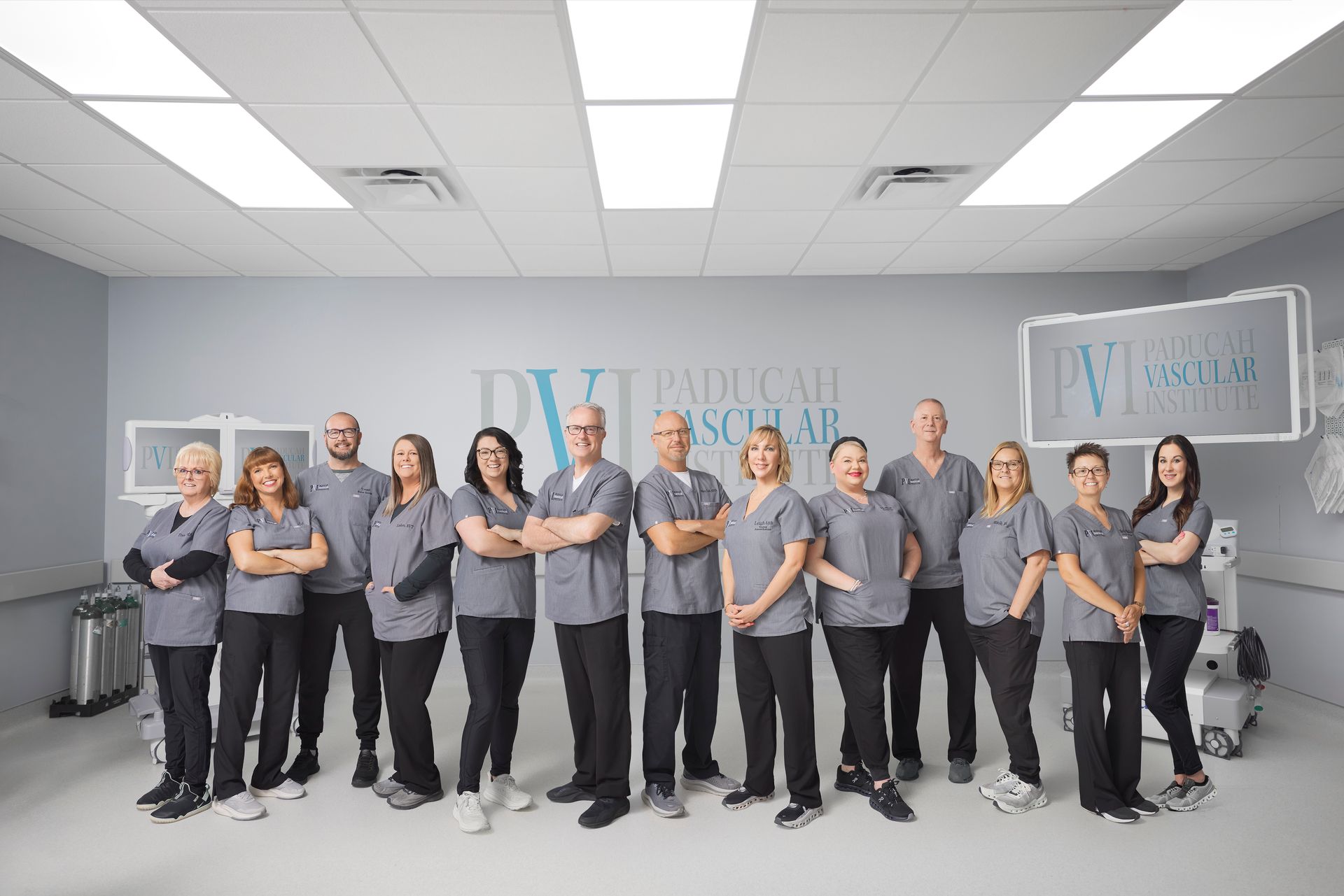 paducah vascular institute staff photo, a group of people standing in the operating room together