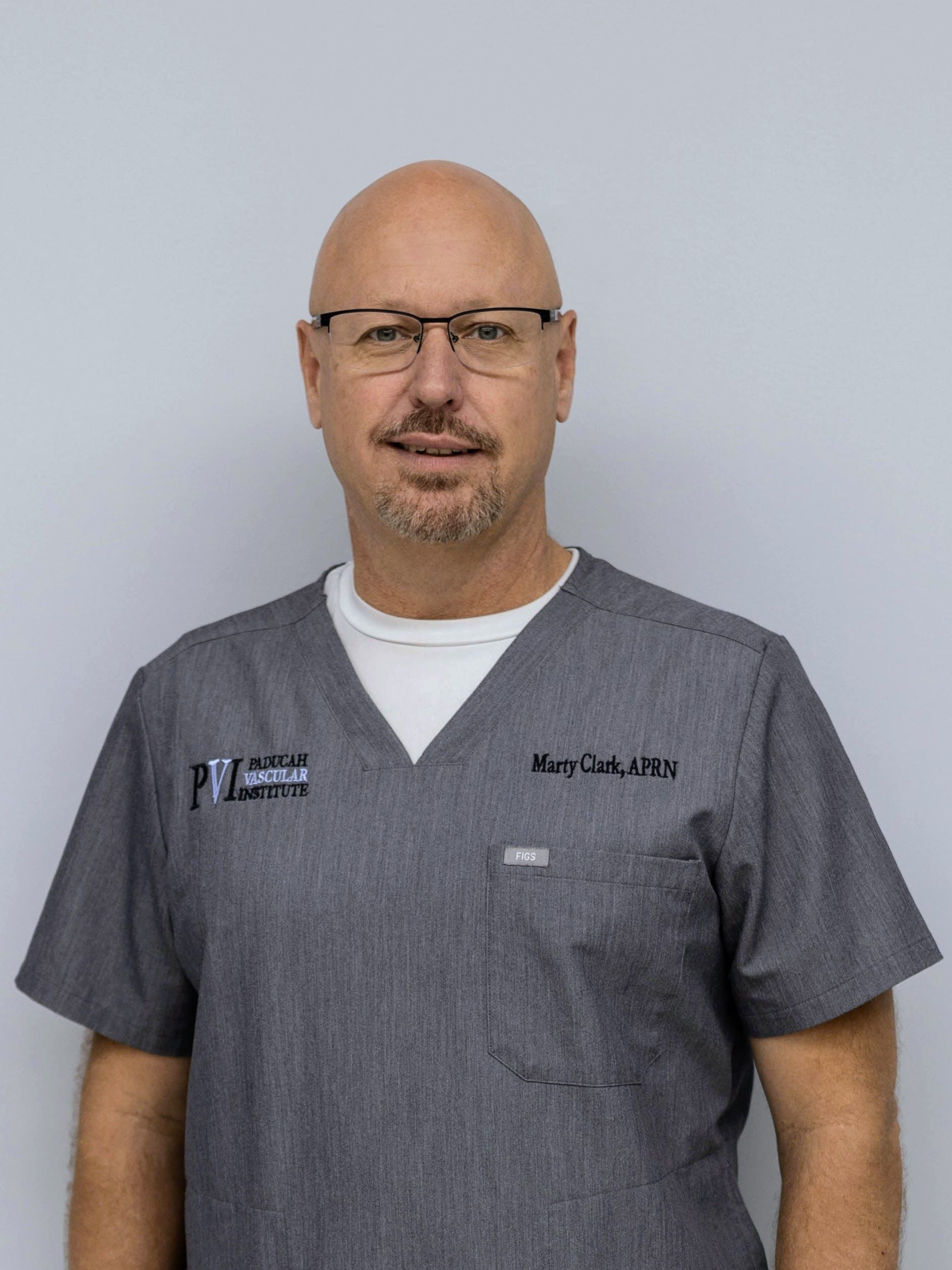 Marty Clark, Advanced Registered Nurse Practitioner, a man wearing a scrub top with paducah vascular institute logo on it
