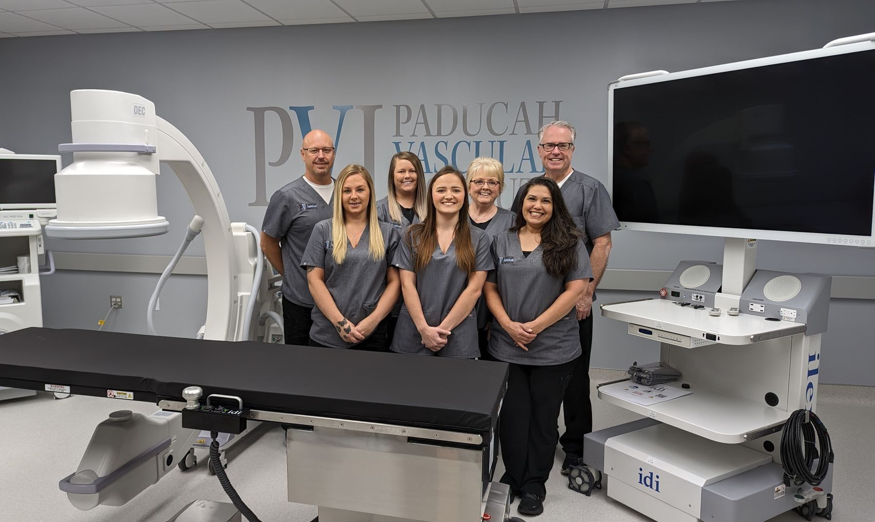 paducah vascular institute staff photo, a group of people standing in the operating room together