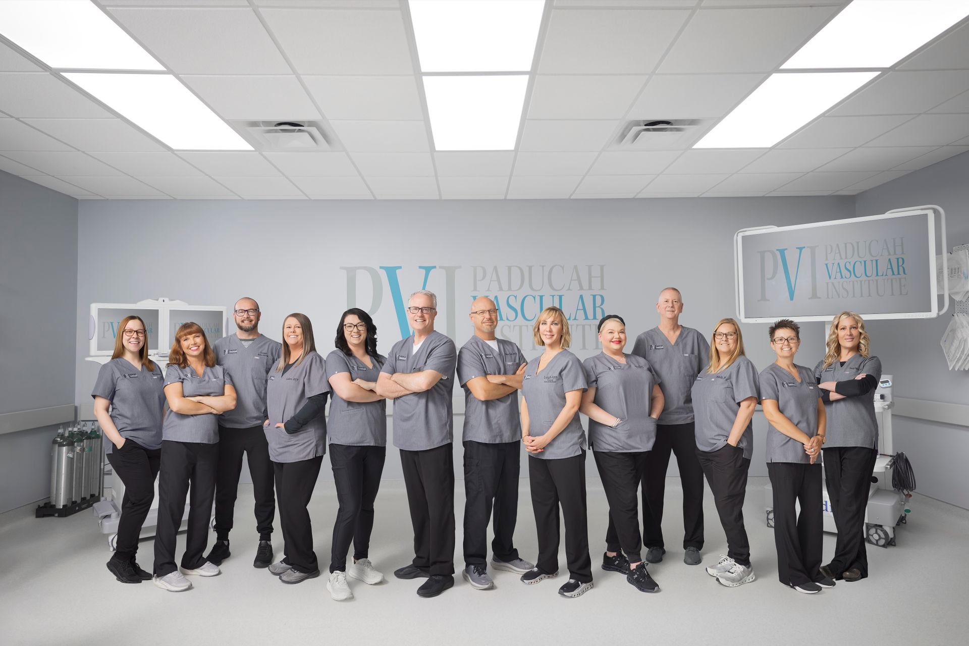 paducah vascular institute staff photo, a group of people standing in the operating room together