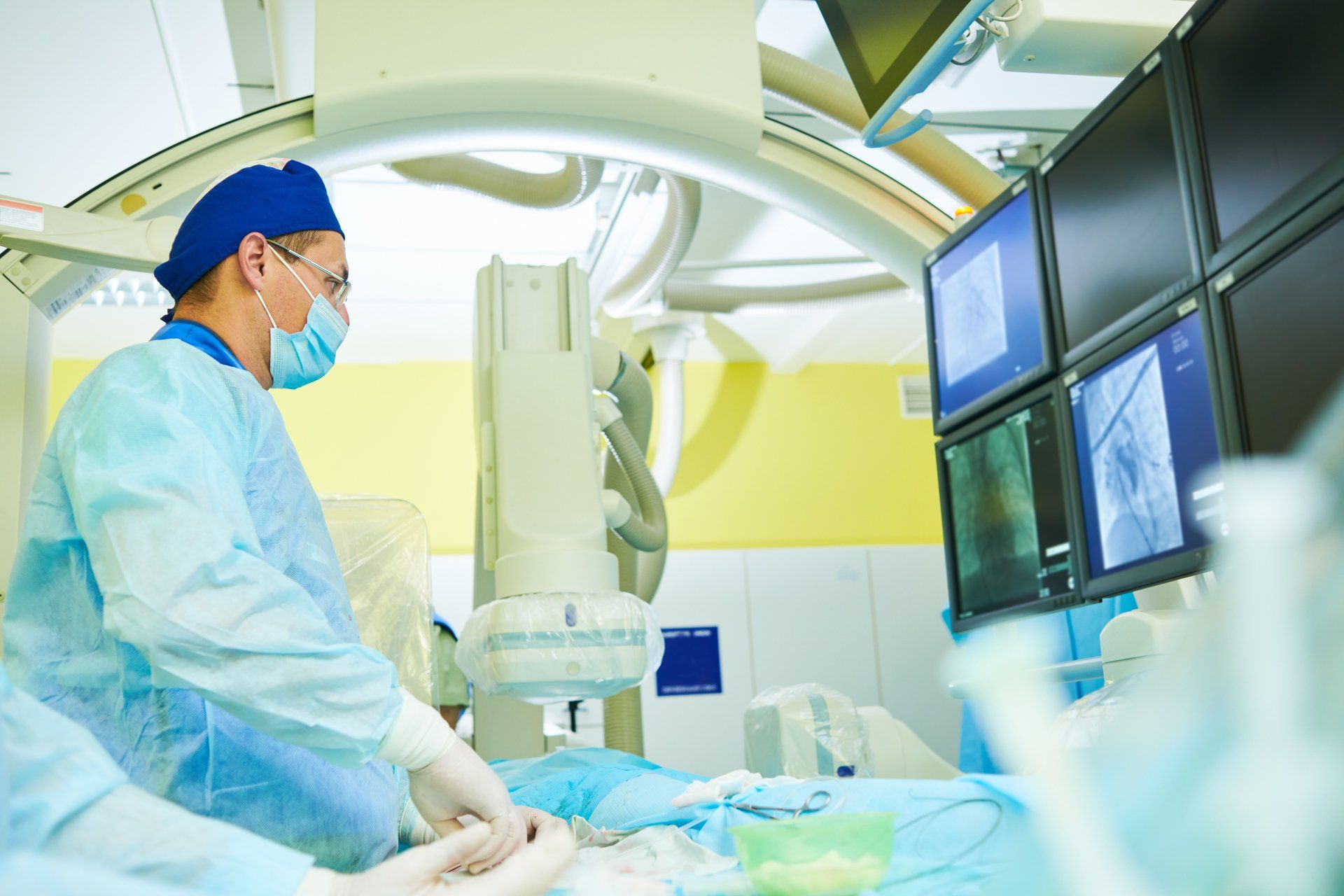 A surgeon is operating on a patient in an operating room.