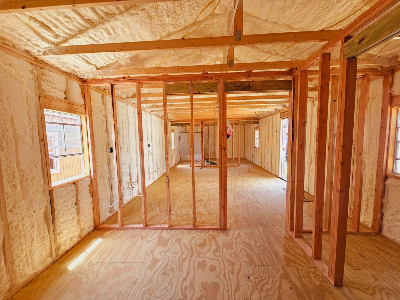 A room in a house under construction with foam insulation on the walls.