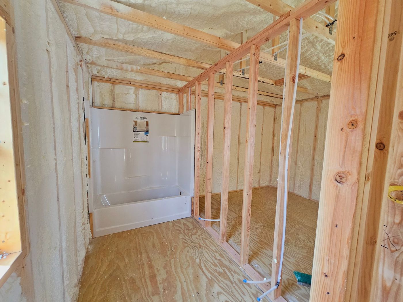 A bathroom under construction with a bathtub and shower.