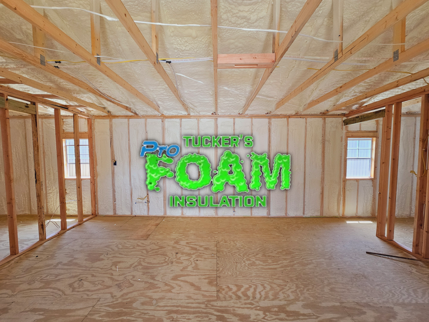 An empty room with foam insulation on the walls and ceiling.