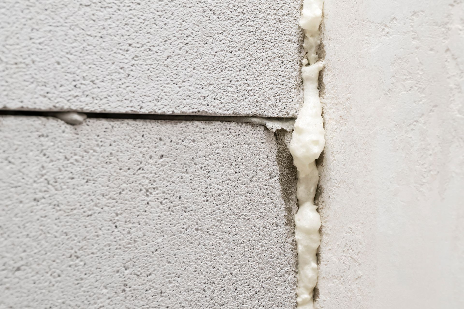 A close up of a brick wall with foam on it.