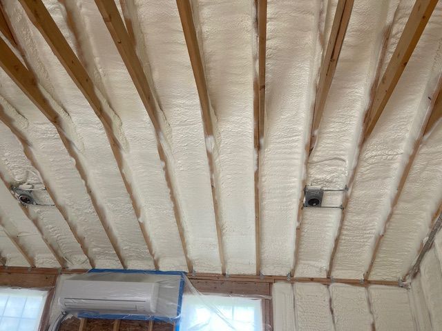 A room with a lot of green insulation on the walls and floor.