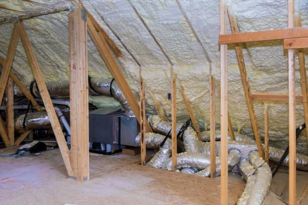 There is a lot of insulation in the attic of a house.
