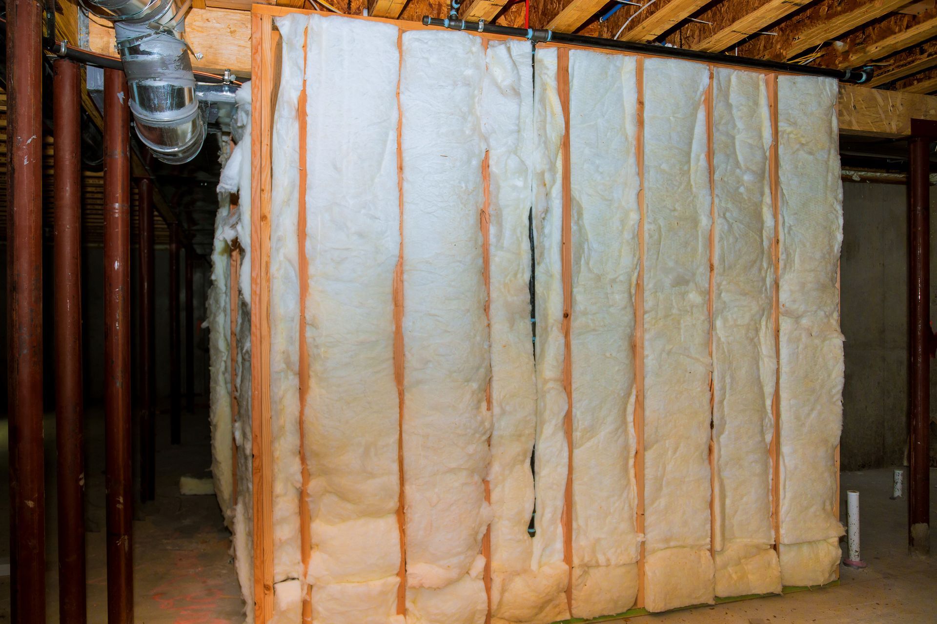 A basement with a lot of insulation on the walls.