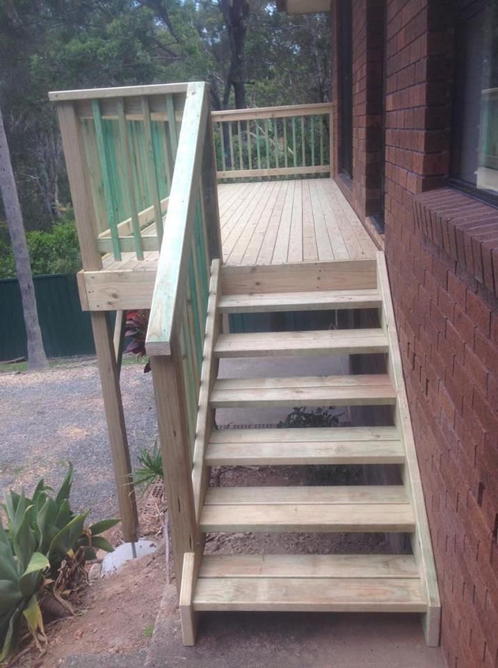 A Wooden Deck With Stairs Leading Up to It Next to a Building — Mark Cannon Carpentry & Maintenance in Moonee Beach, NSW