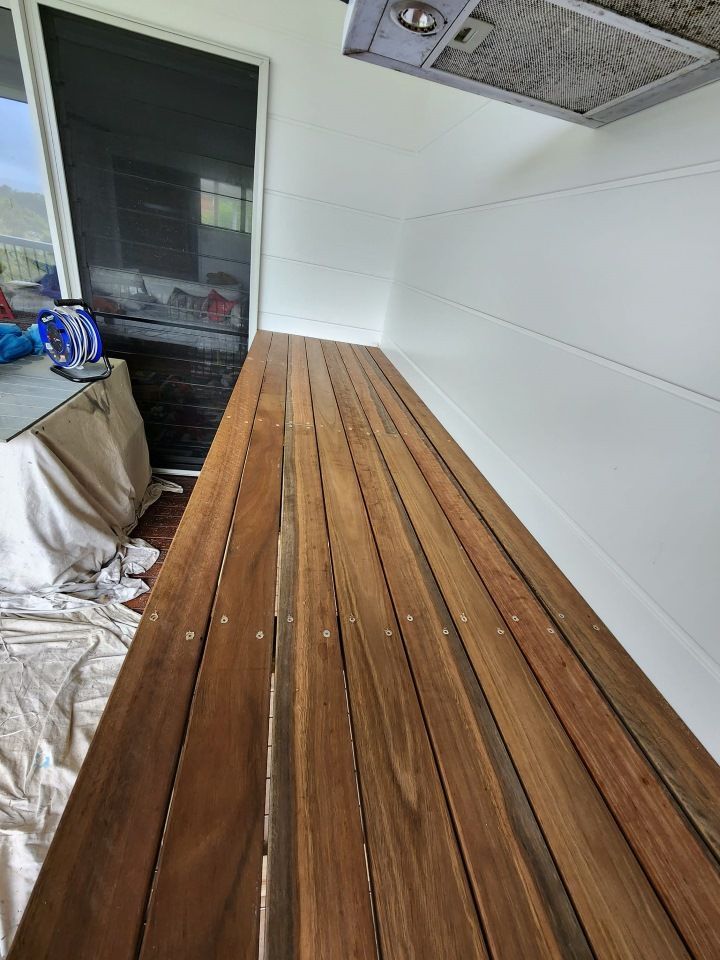 A Wooden Bench is Sitting in a Room Next to a Window — Mark Cannon Carpentry & Maintenance in Moonee Beach, NSW