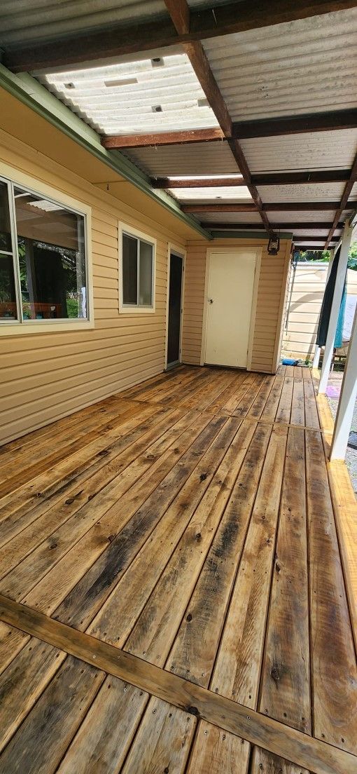 A Wooden Deck is Being Built on the Side of a House — Mark Cannon Carpentry & Maintenance in Moonee Beach, NSW