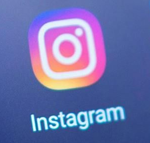 Instagram app logo: white camera icon within a gradient pink, purple, and orange square. Text reads 