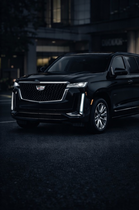 Black Cadillac Escalade SUV parked outside.