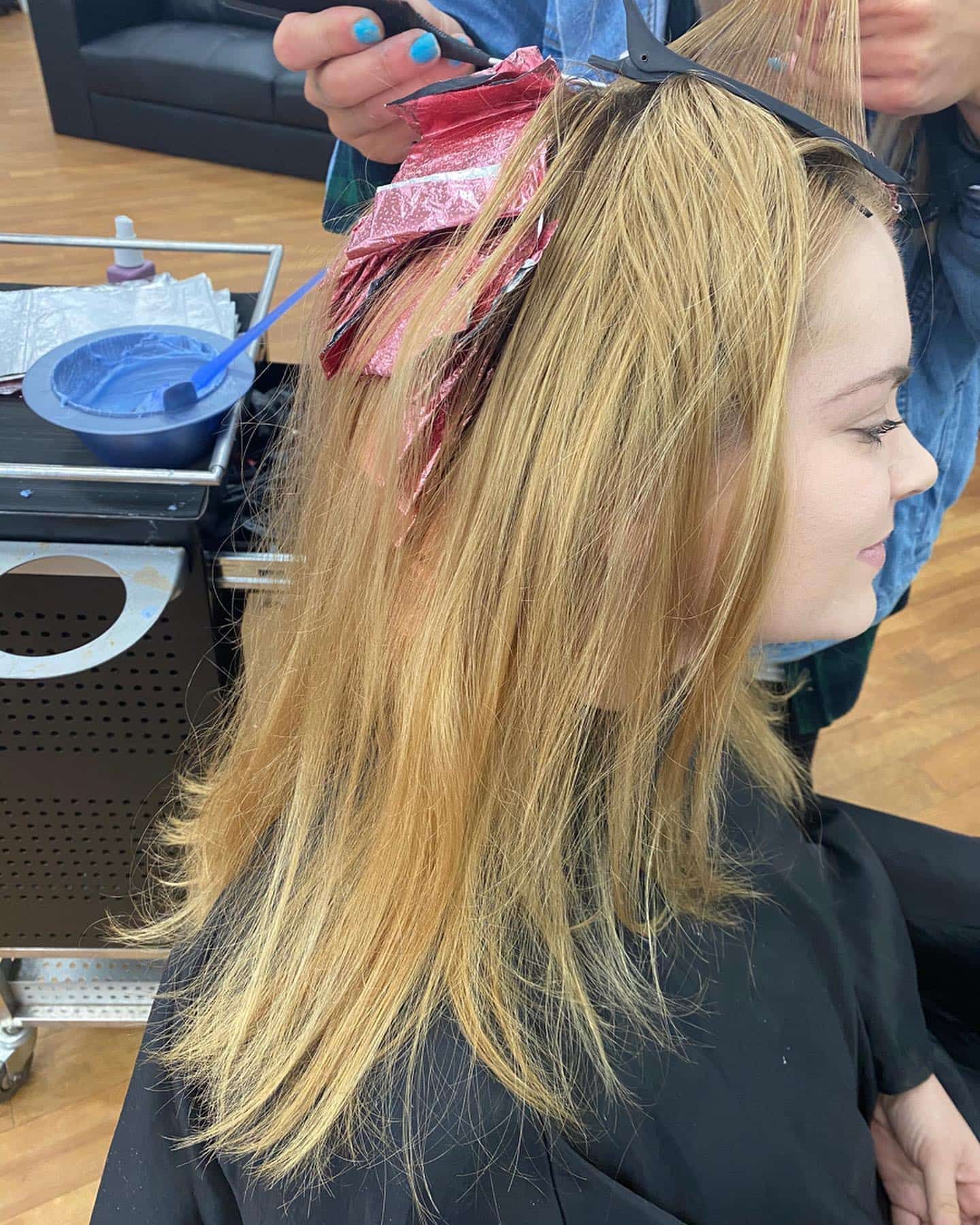 Woman Getting Hair Highlighted With Foils in a Salon — Lavish Hair in Shepparton, VIC