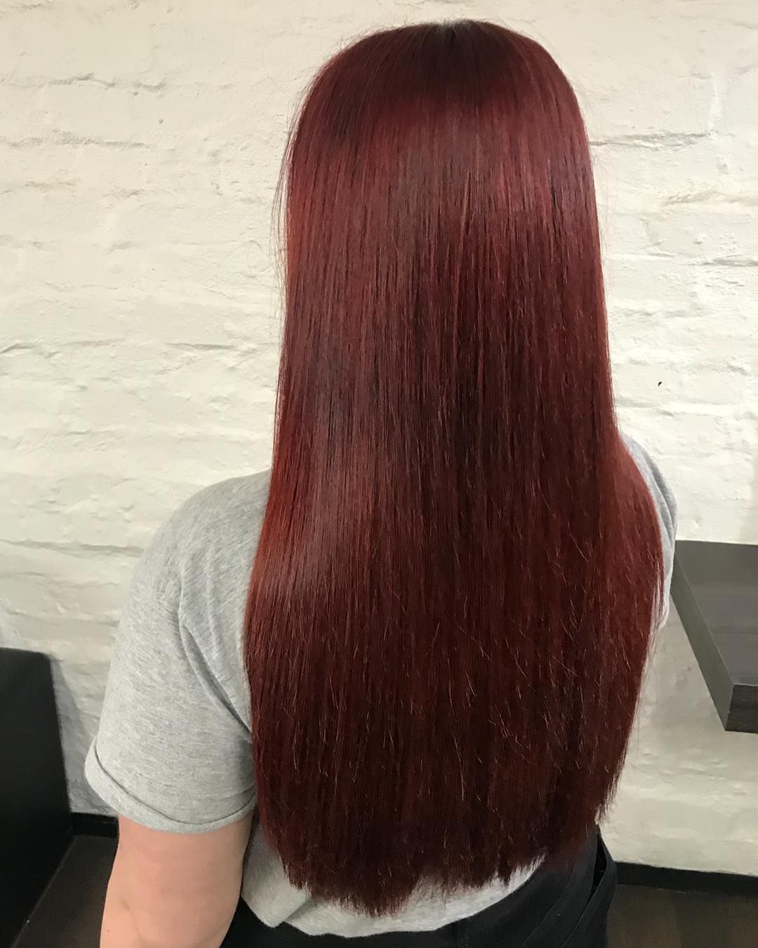 Woman With Long, Straight, Red Hair, Against a White Brick Wall — Lavish Hair in Shepparton, VIC