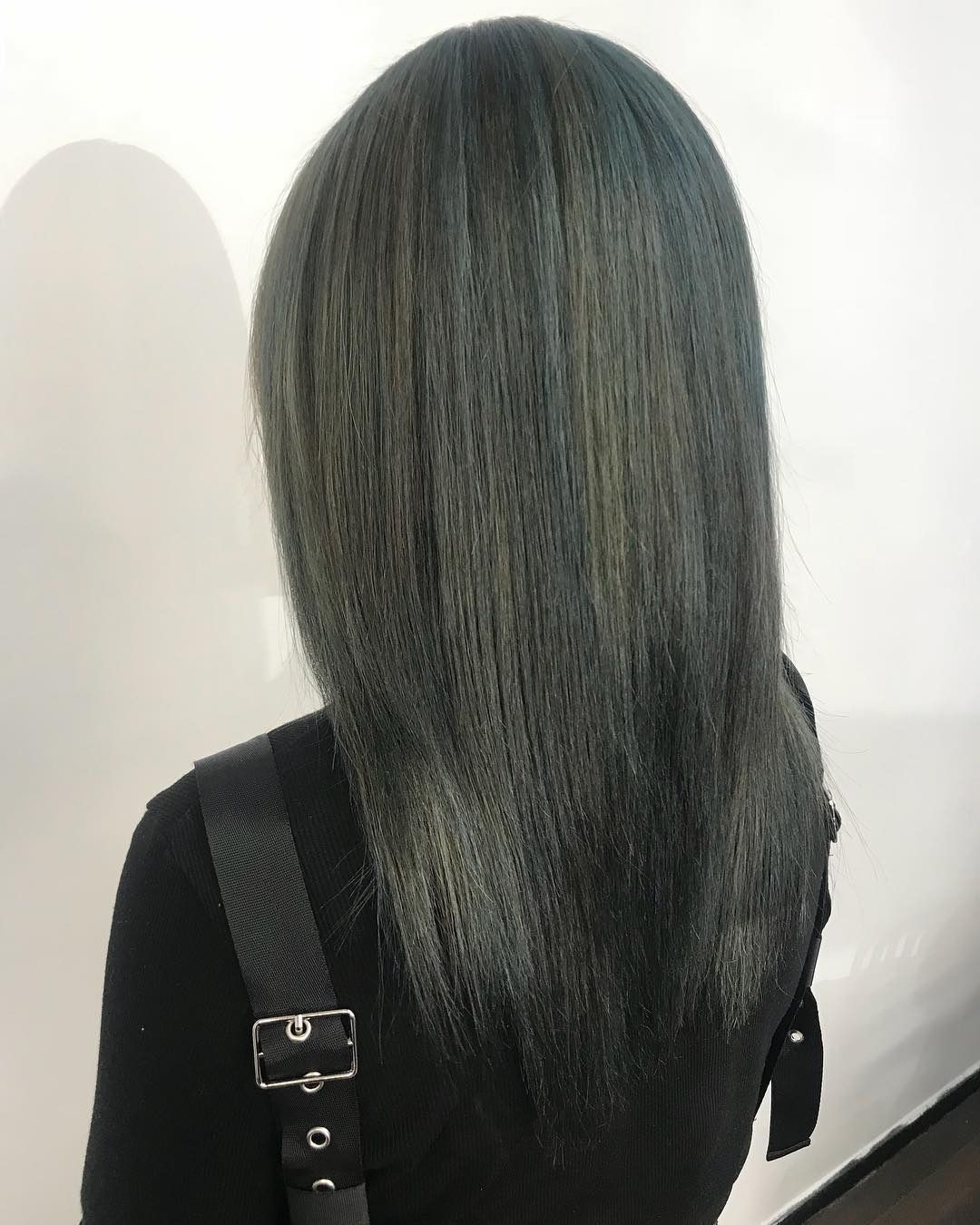 Person With Long, Straight Gray Hair Against a White Wall — Lavish Hair in Shepparton, VIC