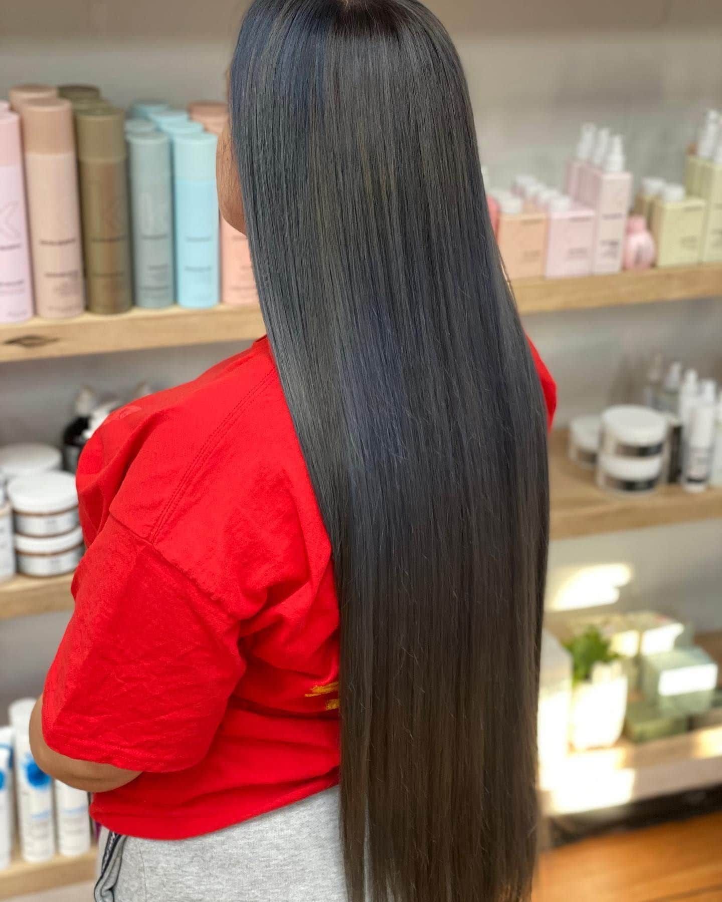 Person With Long, Straight, Dark Gray Hair, Wearing a Red Shirt in a Salon — Lavish Hair in Shepparton, VIC