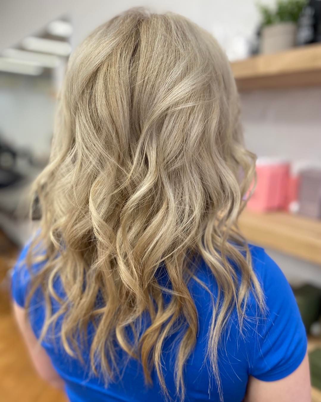 Blonde Hair With Soft Waves. Person in a Blue Shirt — Lavish Hair in Shepparton, VIC