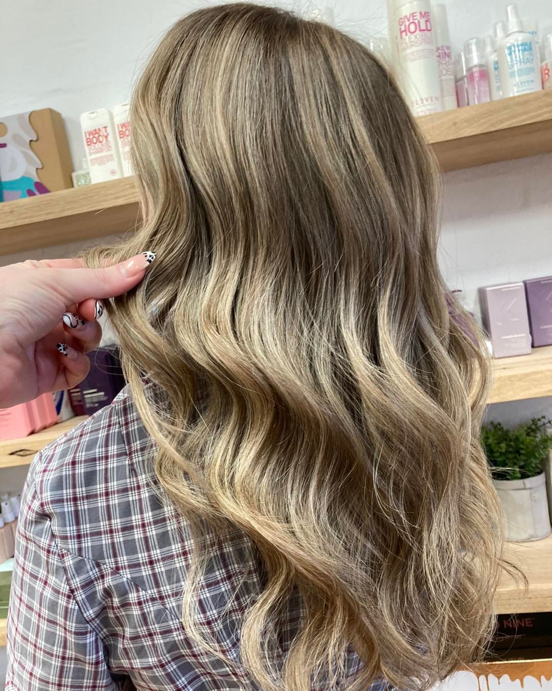Woman With Wavy, Highlighted Hair, Hand Touching Strands — Lavish Hair in Shepparton, VIC