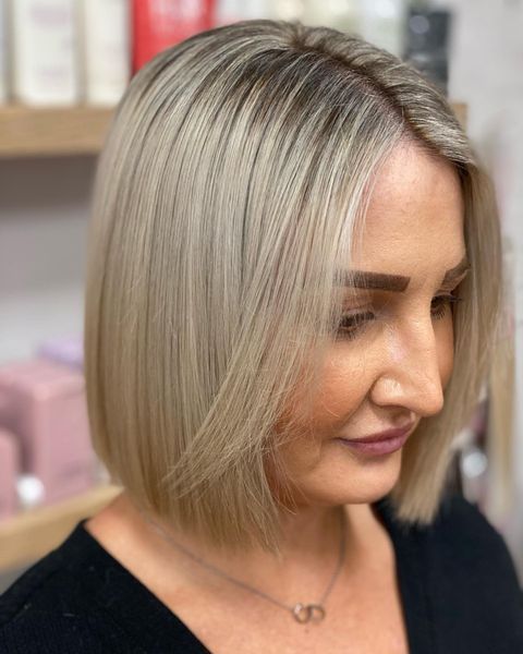 Woman With Blonde Bob Hairstyle, Soft Features, in a Salon Setting — Lavish Hair in Shepparton, VIC