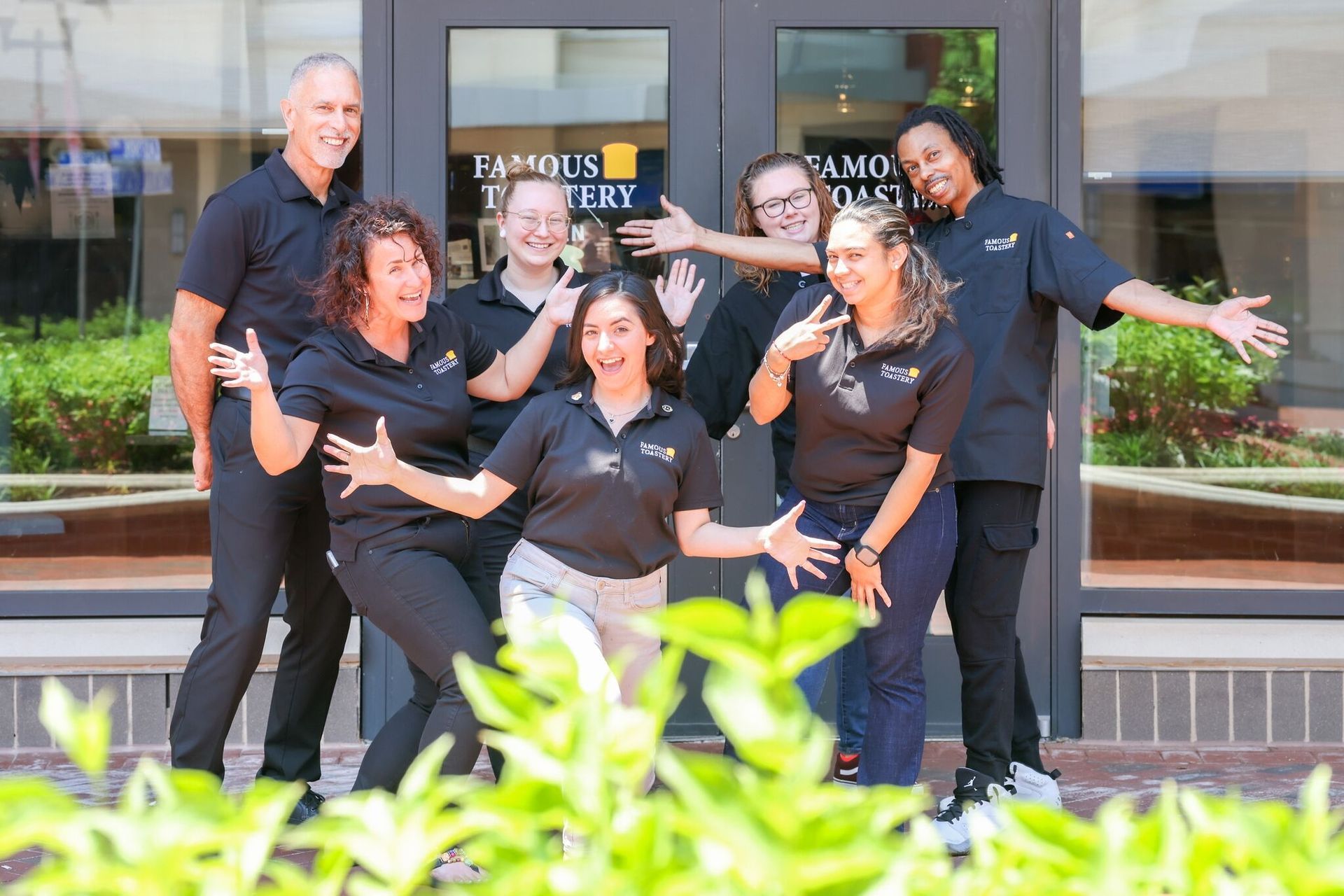 A group of people are posing for a picture in front of a building.