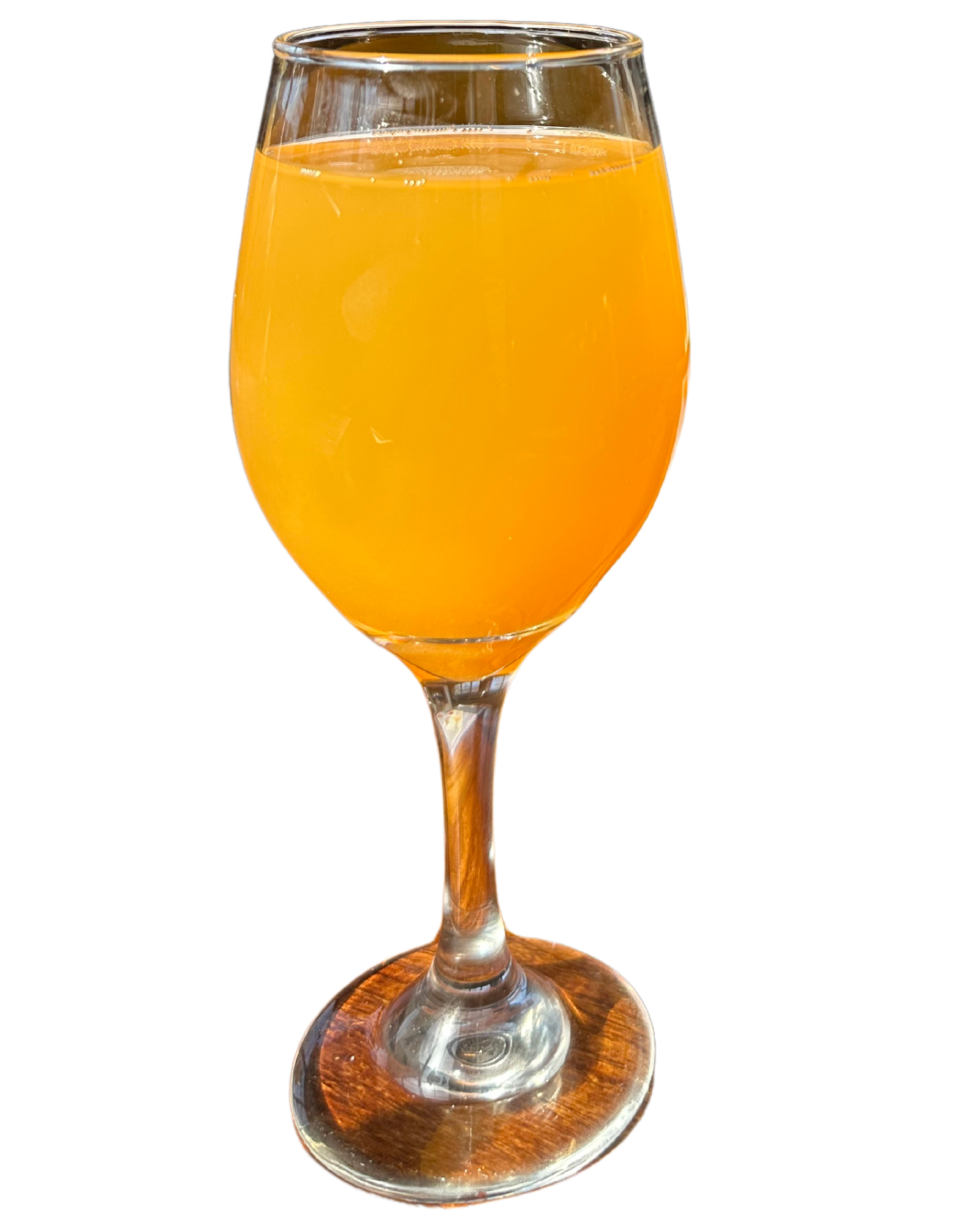 A wine glass filled with orange juice on a white background.