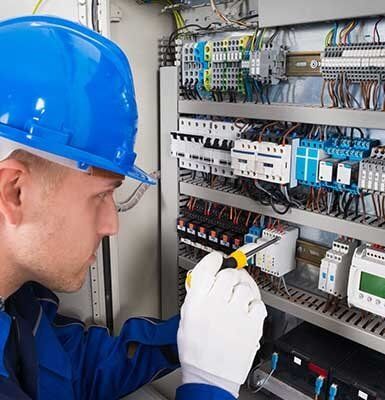 Male Electrician Examining Fusebox — electrical in North Central, VW