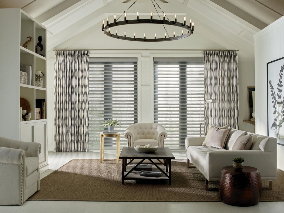 Patterned Hunter Douglas drapes paired with Hunter Douglas shutters