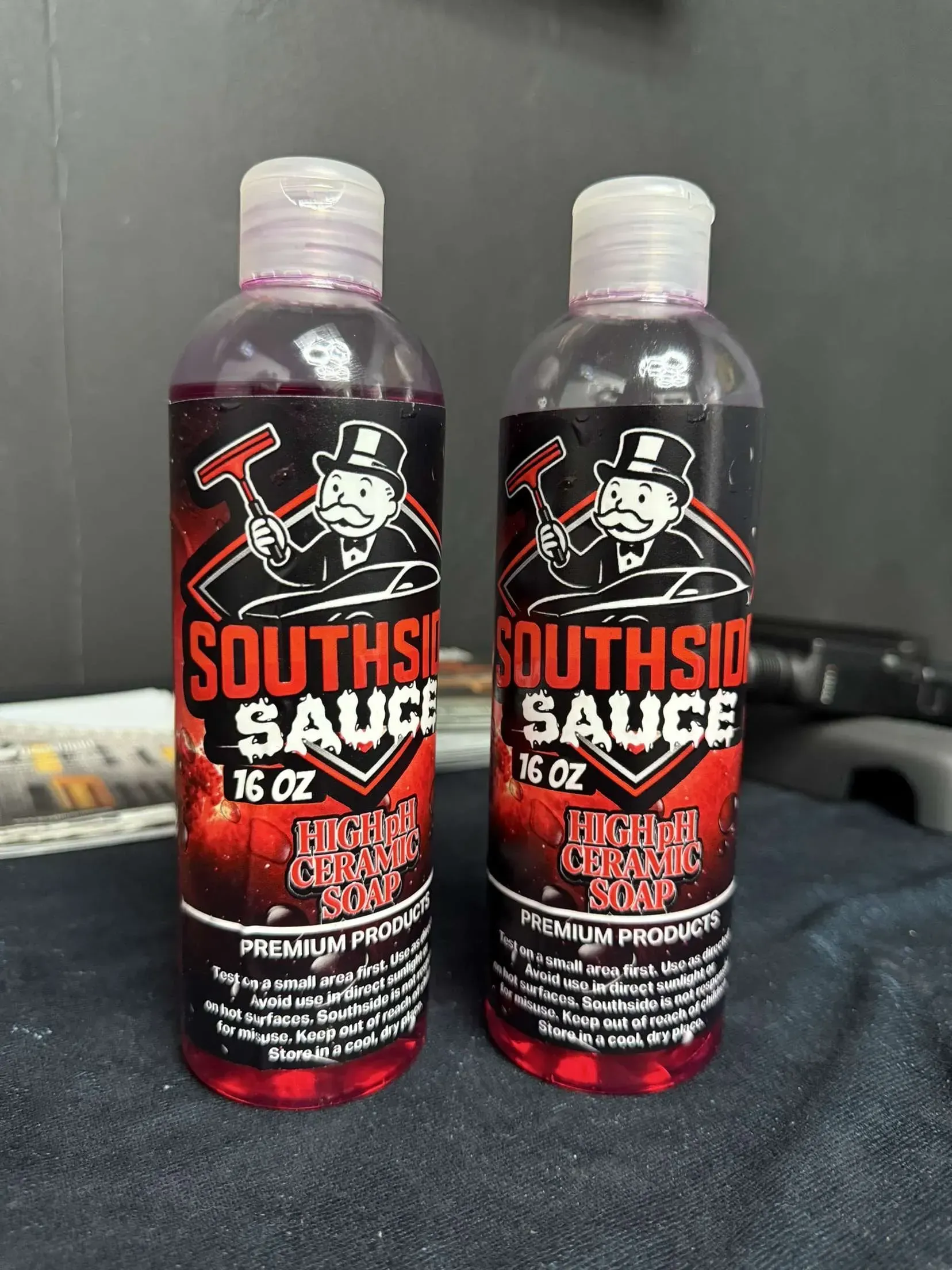 Two bottles of Southside Sauce, 16 oz each, with a label depicting a man in a top hat and a hammer.