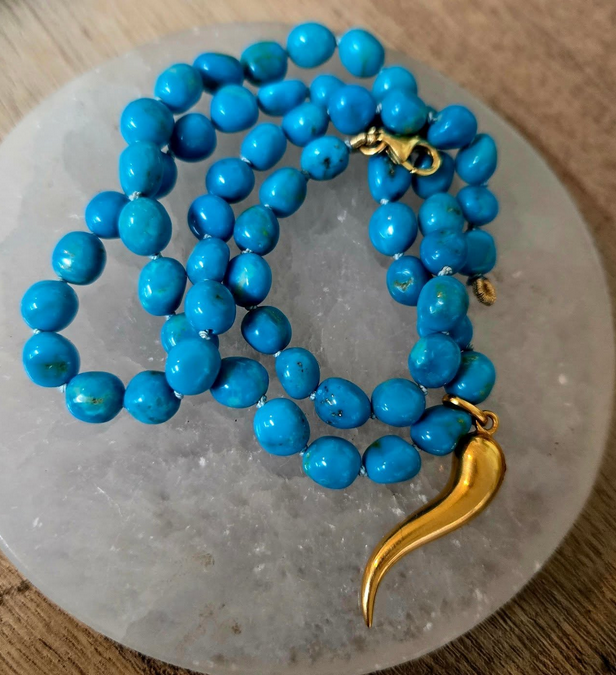 Close-up of a collection of smooth, colorful stones and beads in various shapes and sizes.