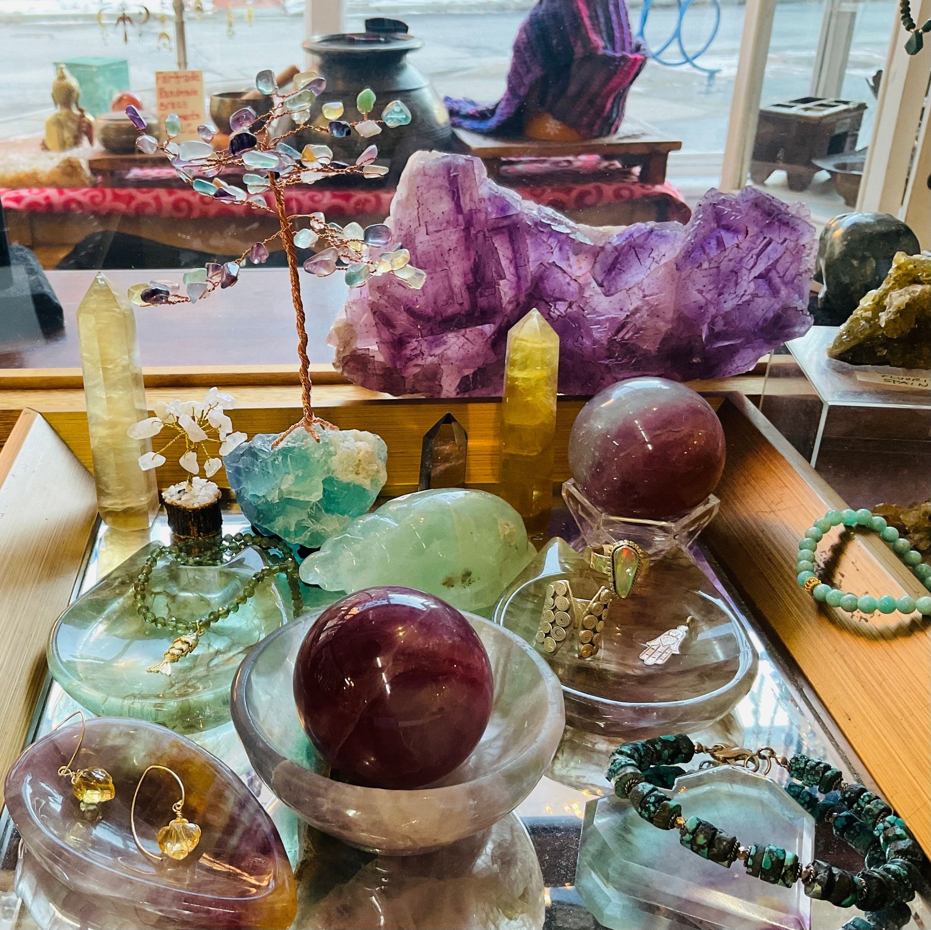 Close-up of colorful, translucent glass beads scattered on a textured brown surface.