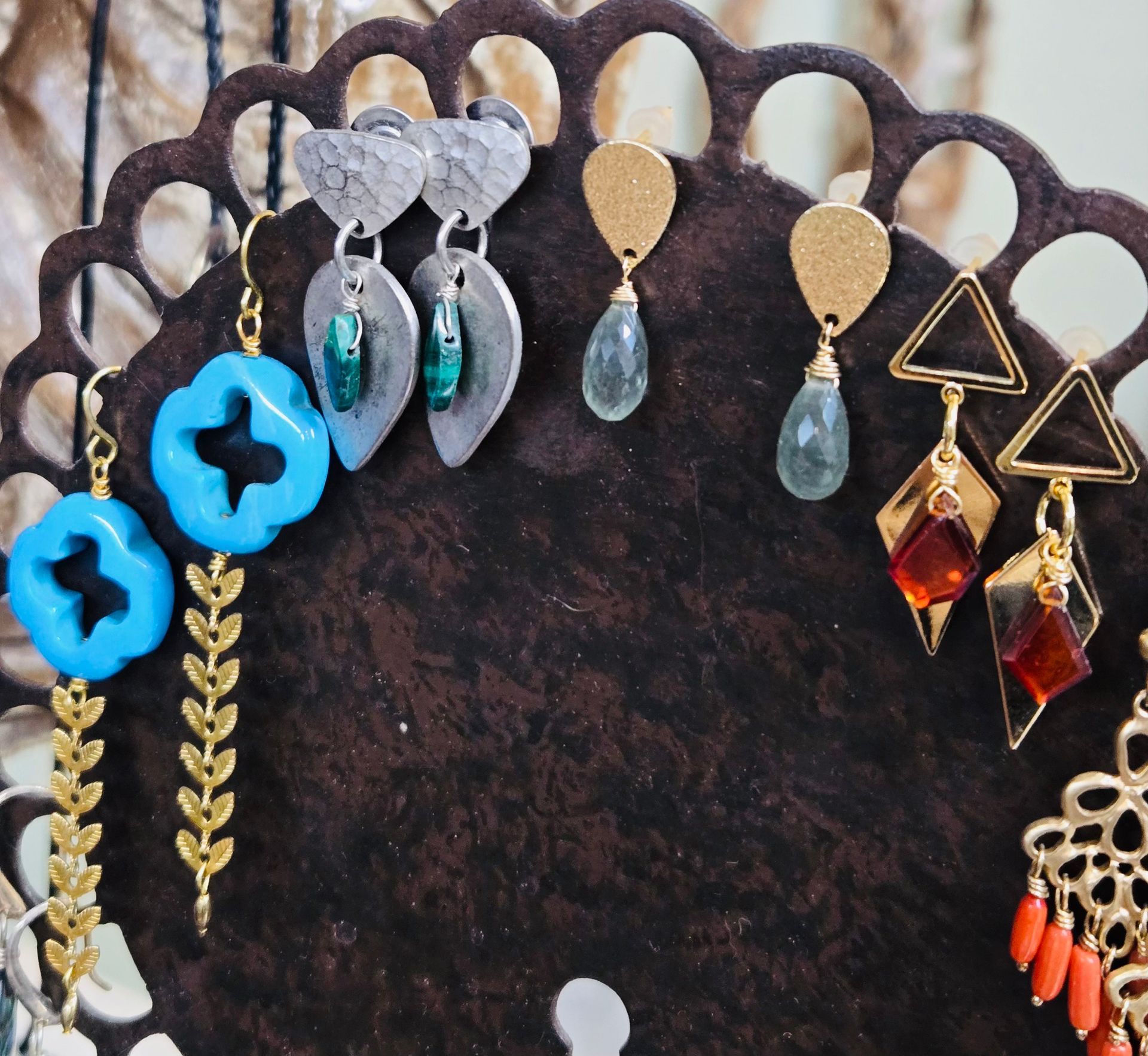 Strings of colorful beads on display, arranged in rows.