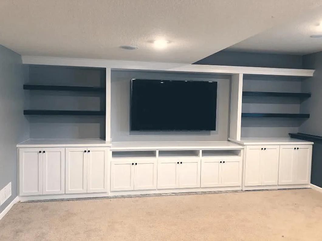 A large entertainment center with a flat screen tv