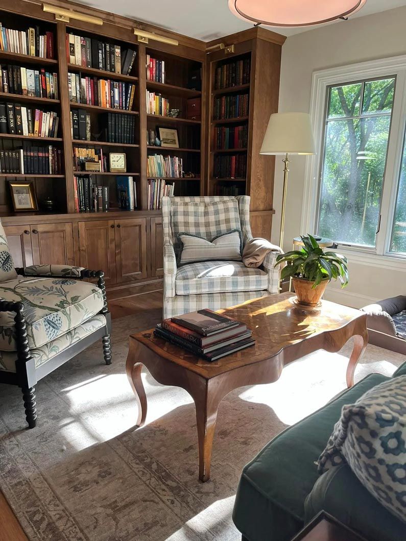 A living room filled with furniture and bookshelves.