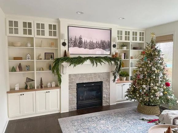 A living room decorated for christmas with a fireplace and a christmas tree.
