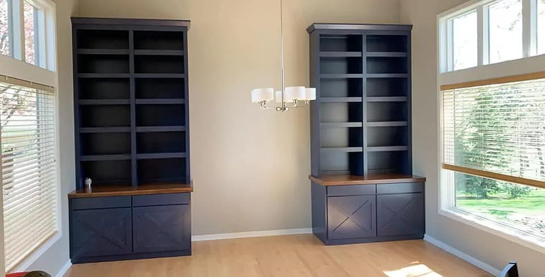 A living room with two shelves and a chandelier.