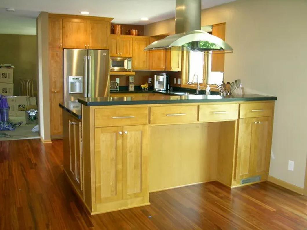 A kitchen with stainless steel appliances and wooden cabinets