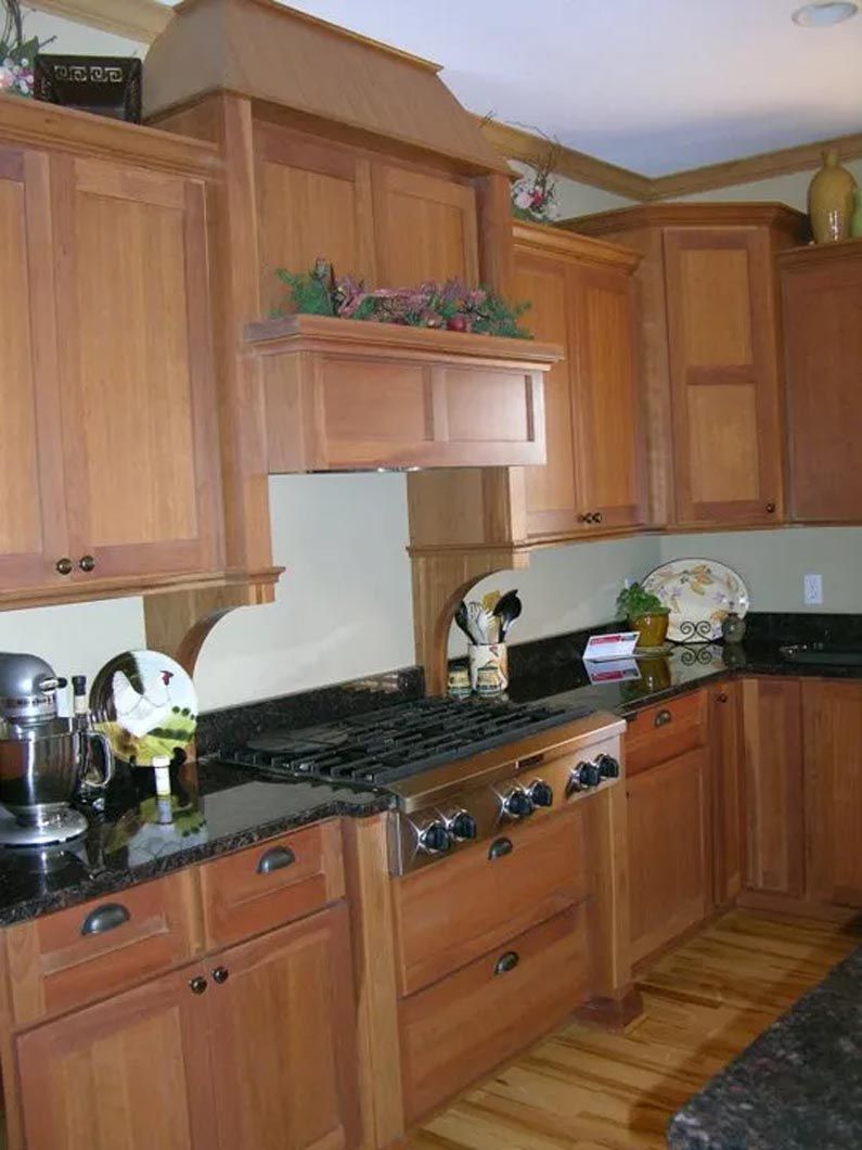 A kitchen with wooden cabinets and granite counter tops